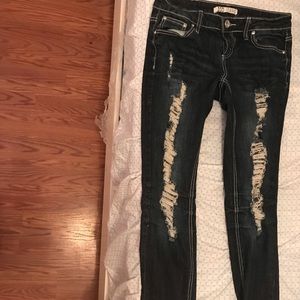 Dark wash ripped jeans.